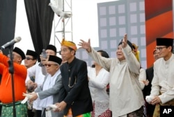 Presiden Joko Widodo, kiri tengah, dan pasangannya Ma'ruf Amin, kiri, dan lawannya Prabowo Subianto, kanan tengah, dengan pasangannya Sandiaga Uno, kanan, melepaskan burung dalam upacara yang menandai dimulainya periode kampanye untuk pemilu 2019 di Jakarta (Foto: AP)